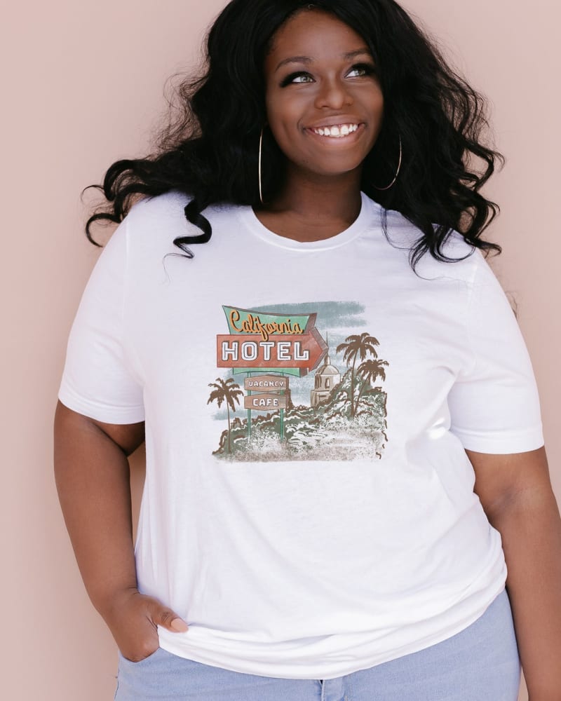 Front of a model wearing a size 2XL California Hotel in White by Simply Sage Market. | dia_product_style_image_id:281373